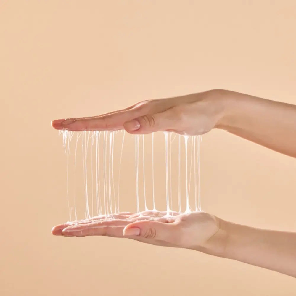 Stretchy silk texture of Korean Heartleaf PDRN moisturizing cream shown between two hands