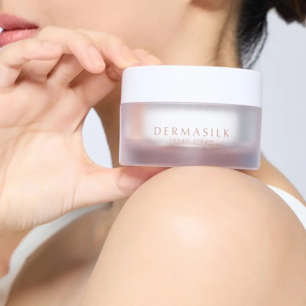 Woman holding INCELLA Heartleaf PDRN Repair Cream during her moisturizing skincare routine